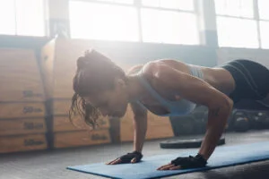 15 10 challenge young woman doing press ups